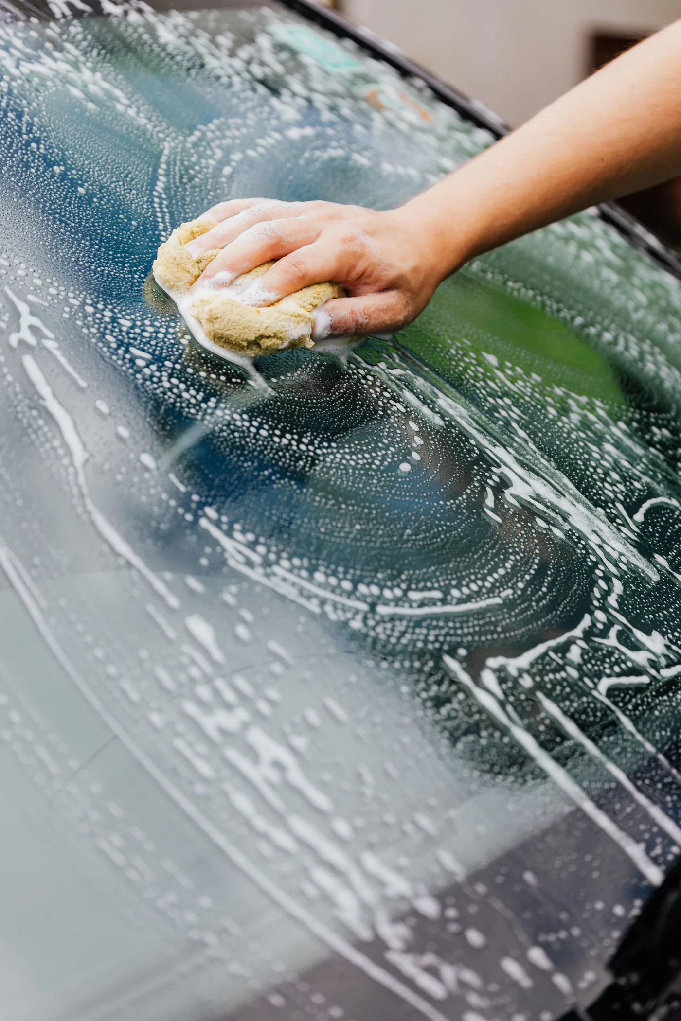 Hand washing a vehicle windshield