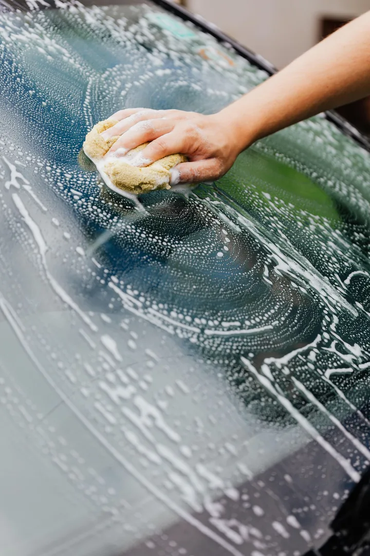 Hand washing a vehicle windshield